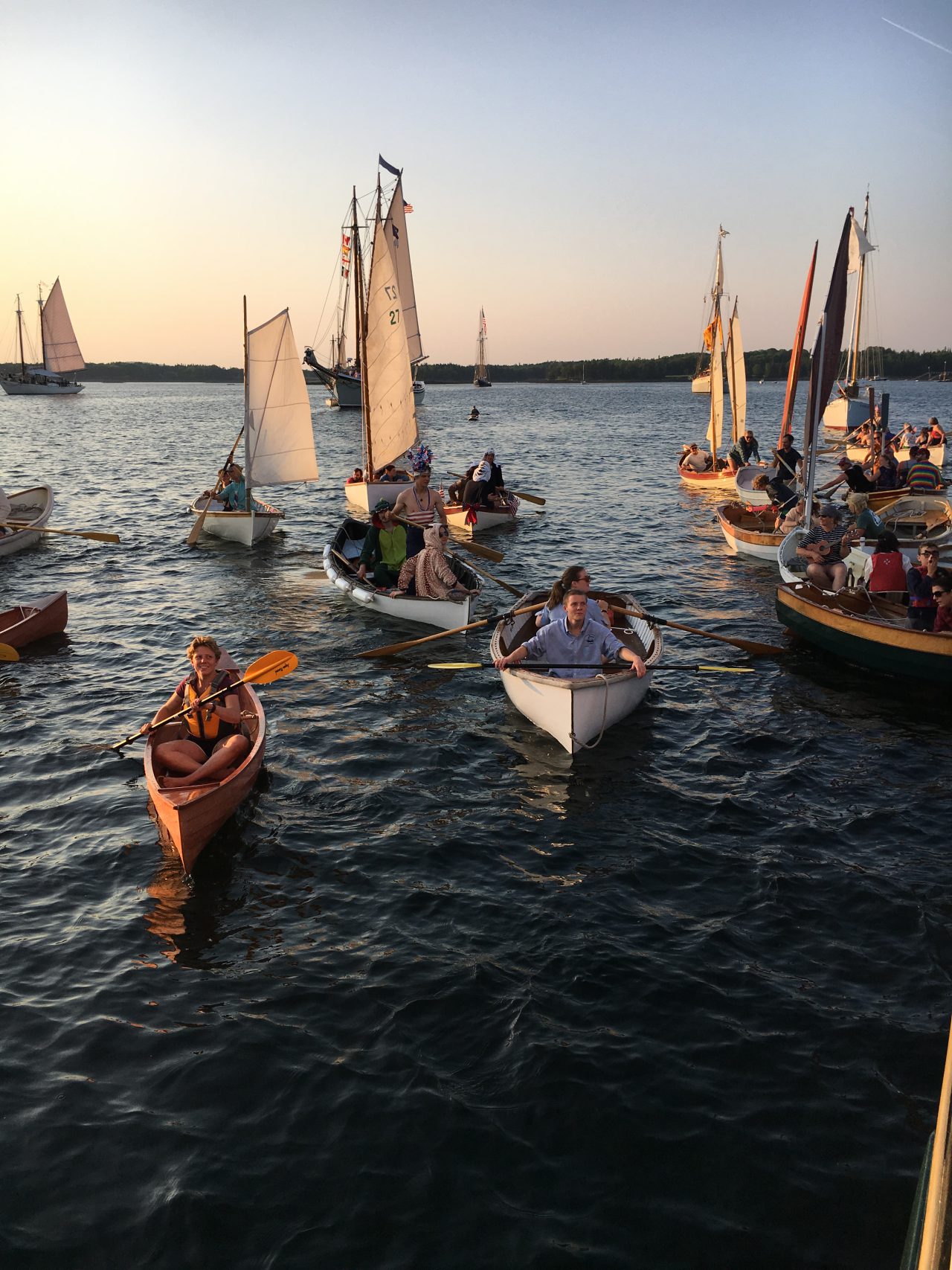 rowboats and sailing dingys gather for the small boat race